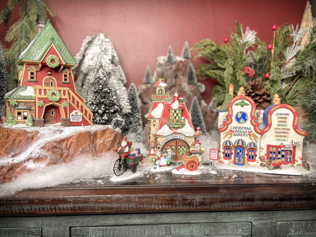 Shows step 5 of setting up a small Christmas village display: adding snow