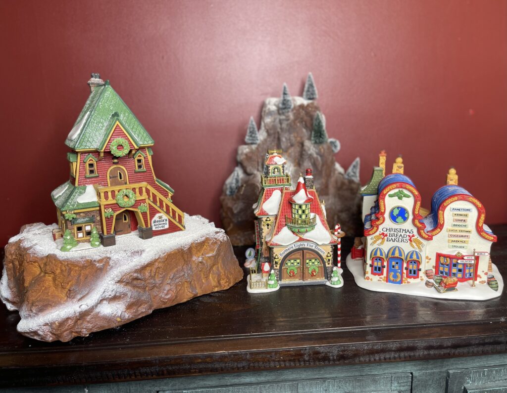 Shows step 3 of setting up a small Christmas village display: adding landscaping