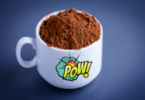 a mug full of how cocoa powder with the word "pow" on the mug. 