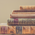 Stack of vintage books that would be great for a Christmas village display