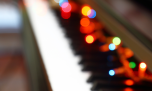 Piano with Christmas lights on it